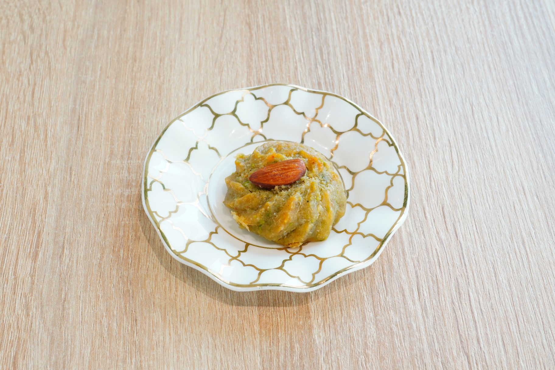 Pistachio ma'amoul topped with a whole almond