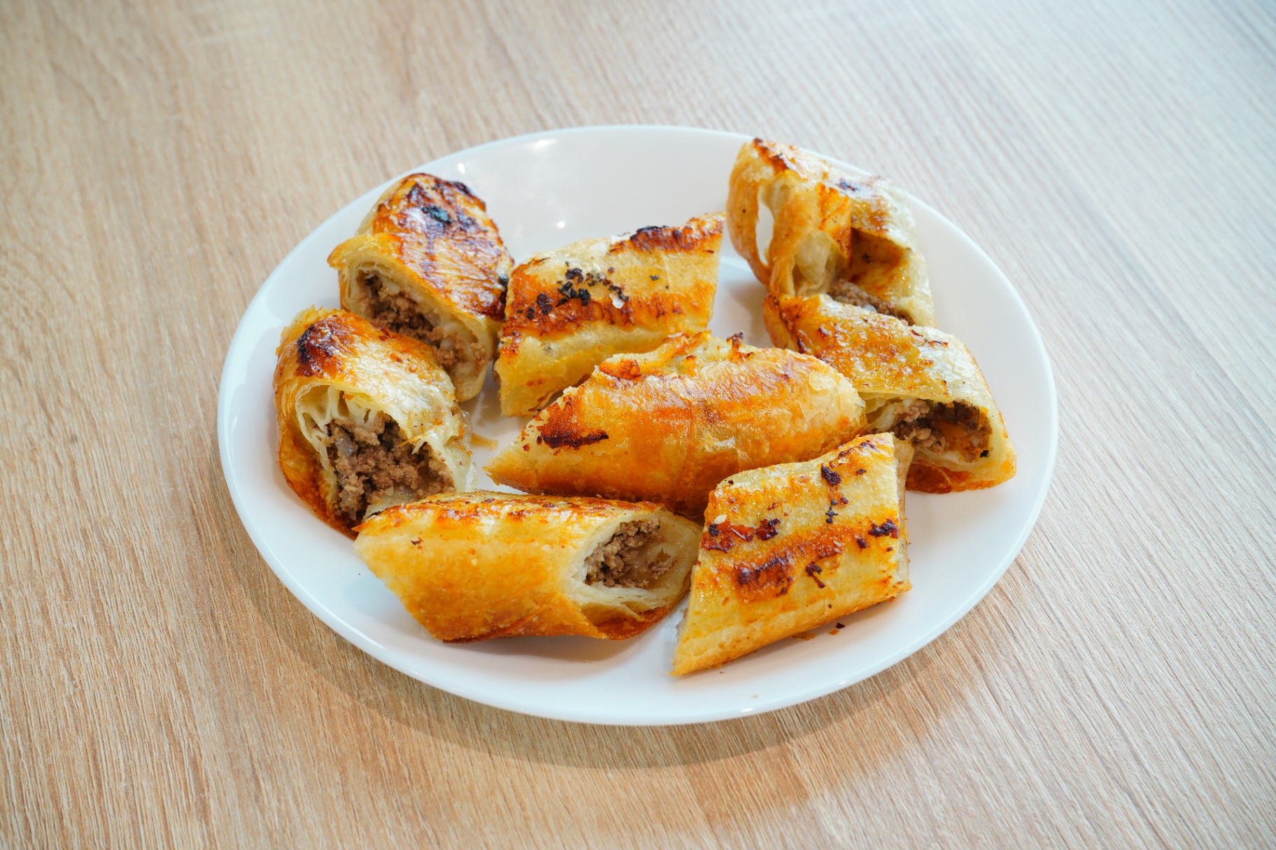 Golden meat-filled puff pastry rolls