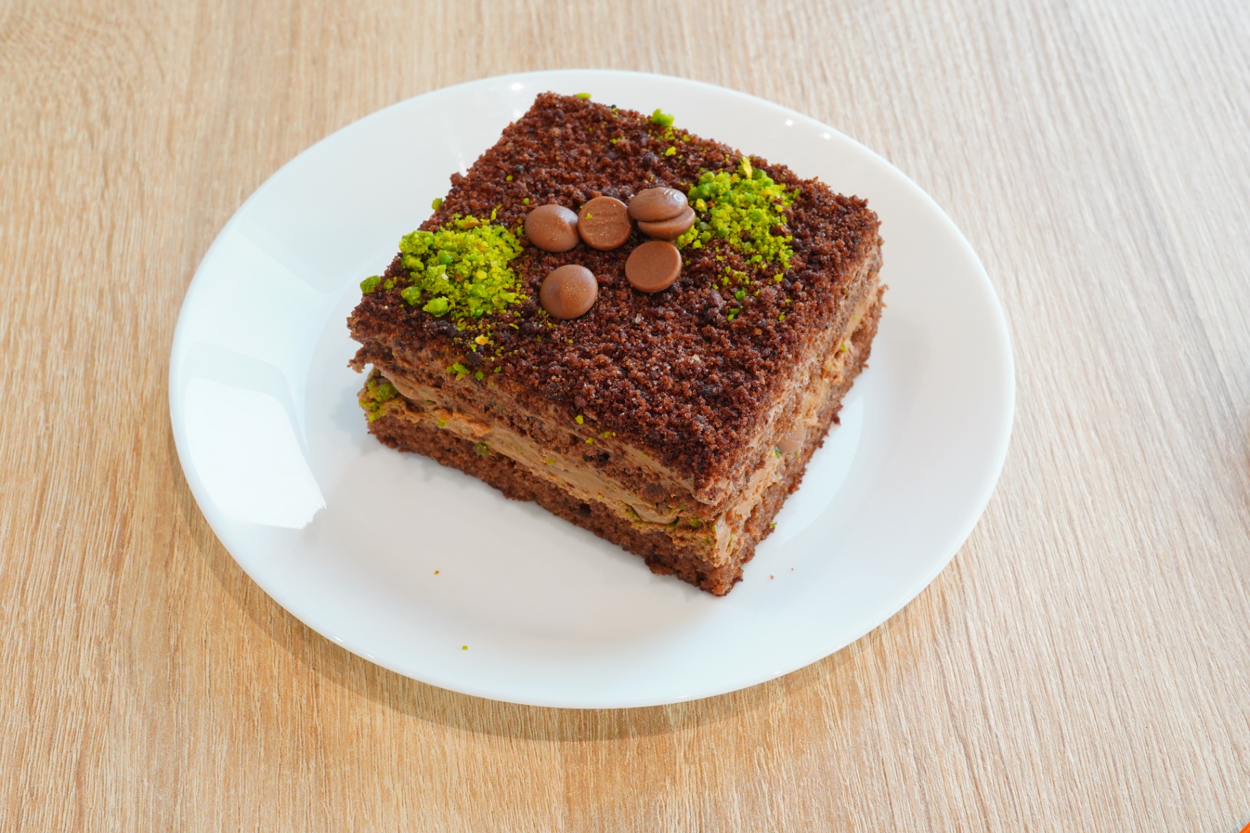 Chocolate pistachio layered cake square