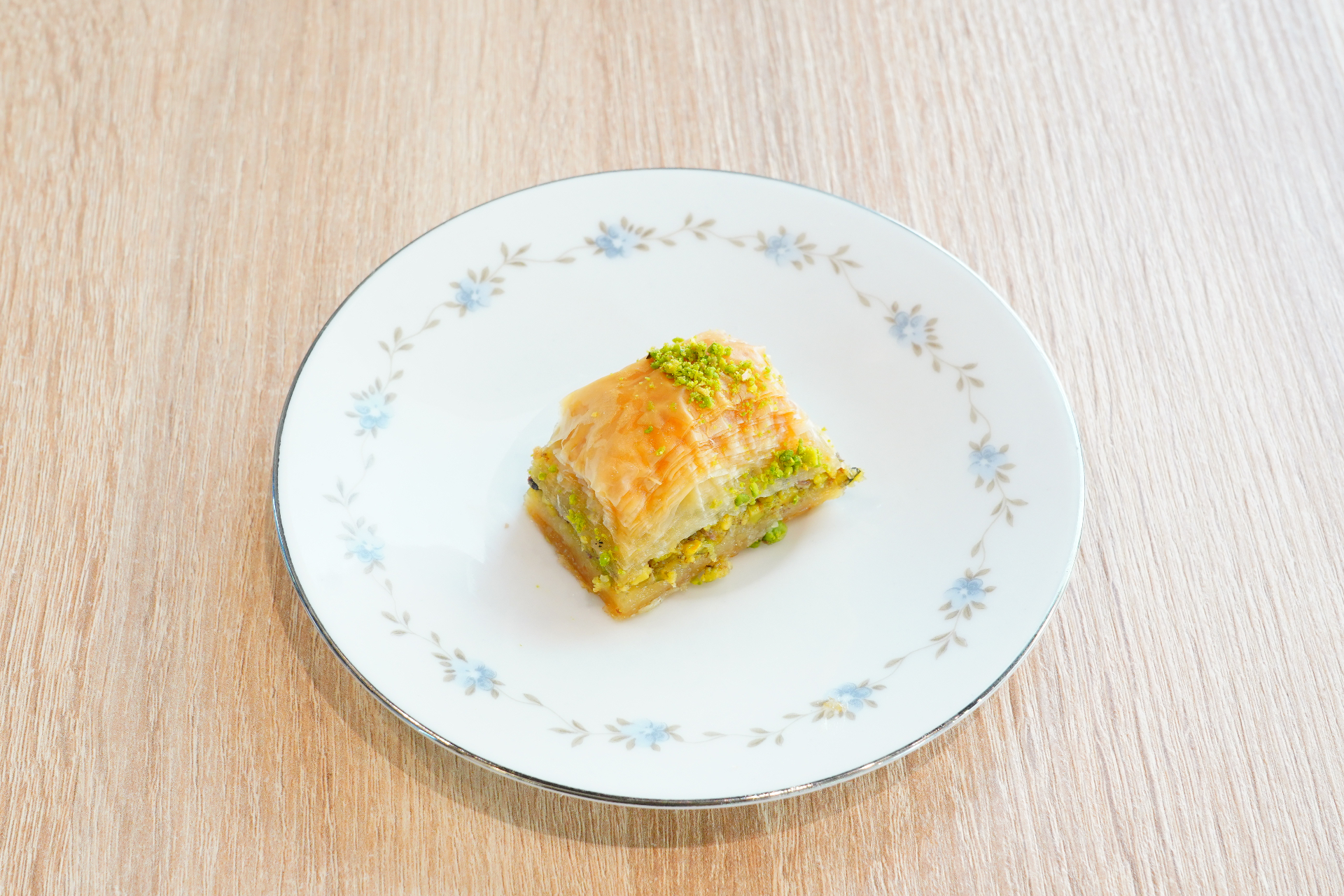 Pistachio baklava on a floral porcelain plate