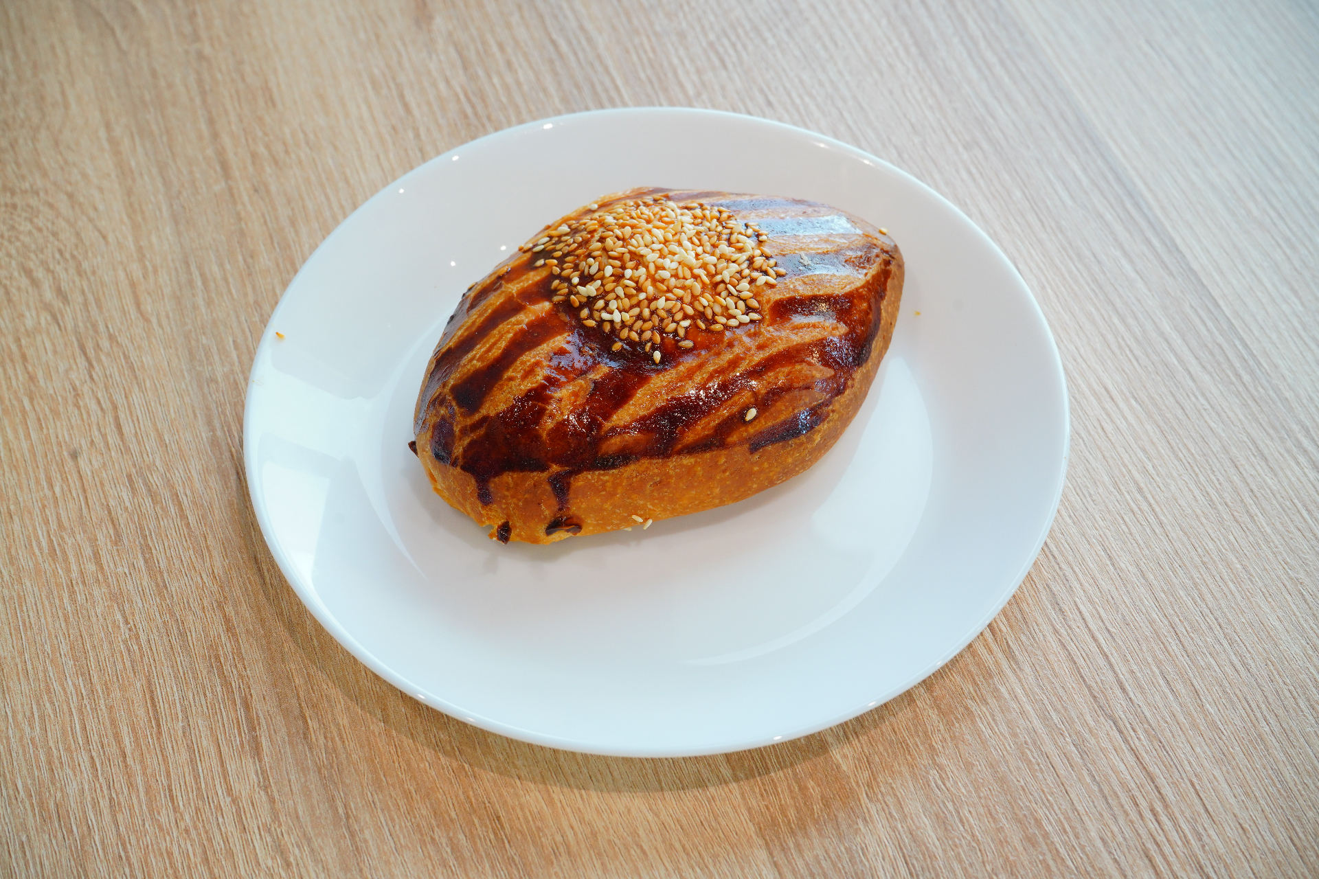 Glazed sesame-topped stuffed bun