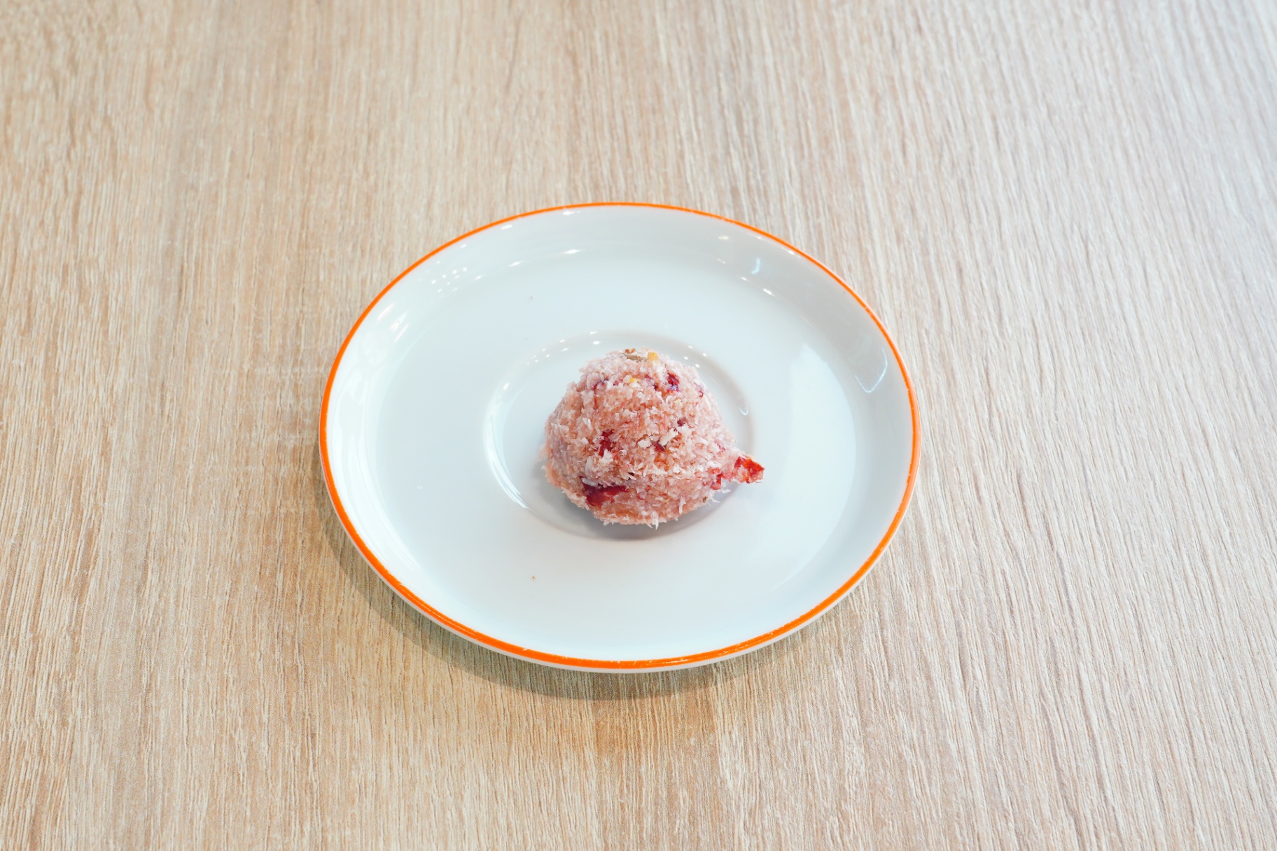 Coconut and rose cookie on a white plate