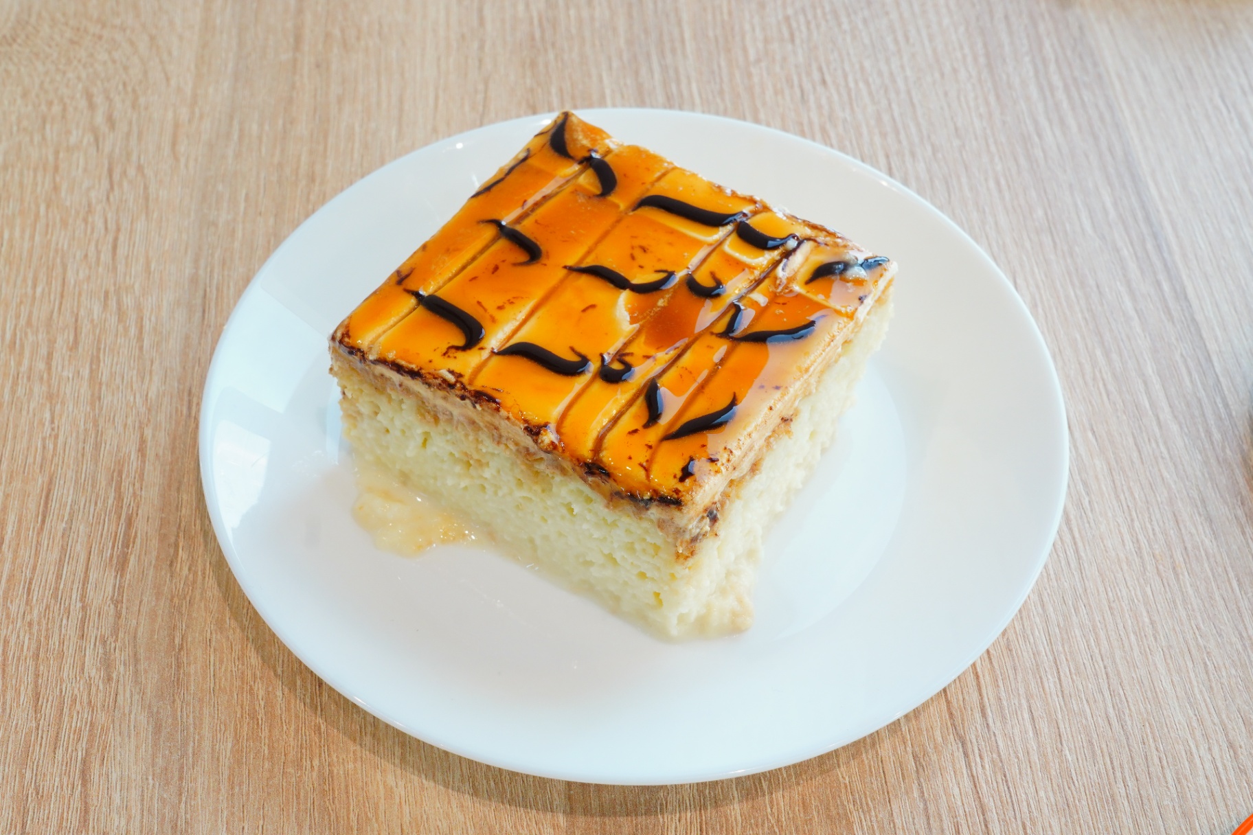 Trilece milk cake with caramel and chocolate drizzle